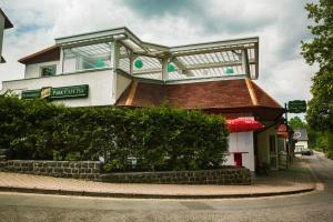 a building with a balcony on top of it at Hotel & Restaurant Park Cafe ISA in Erfurt