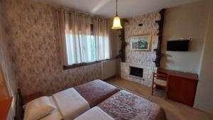 Ένα ή περισσότερα κρεβάτια σε δωμάτιο στο Ziakas Rooms