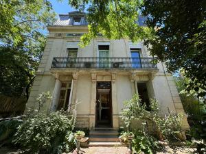 an old house with a balcony on top of it at Hotel Acapulco in Montpellier