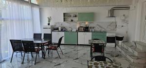 a kitchen with a table and chairs in a room at Vilele Brise de Mer in 2 Mai