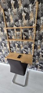 a desk in front of a black and white wallpaper at F2 en centre ville proche gare in Beauvais