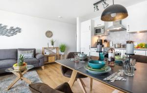 a kitchen and living room with a table and chairs at Strandläufer in Olpenitz