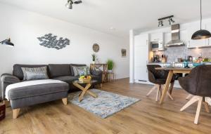 a living room with a couch and a table at Strandläufer in Olpenitz +16 photos