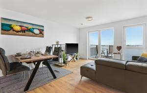 a living room with a couch and a table at Hafendiamant in Olpenitz