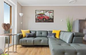 a living room with a gray couch and a red car at Hafendiamant in Olpenitz