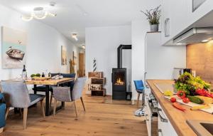 a kitchen and dining room with a table and a fireplace at Ms Admiral in Olpenitz
