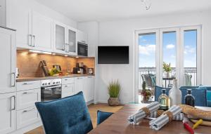 a kitchen with a wooden table and blue chairs at Ms Admiral in Olpenitz