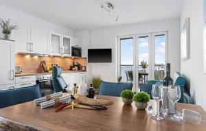 a kitchen and dining room with a wooden table at Ms Admiral in Olpenitz