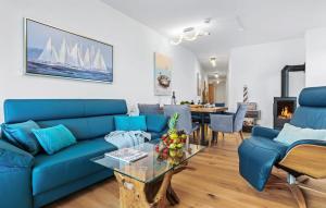a living room with a blue couch and a table at Ms Admiral in Olpenitz +19 photos