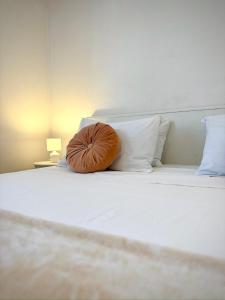 a brown pillow sitting on top of a bed at Pina Hvar Apartment in Hvar
