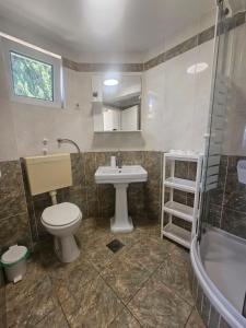 a bathroom with a toilet and a sink and a tub at Guest house Silvija - sea view in Primošten +107 photos