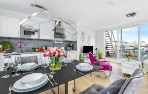 a kitchen and living room with a table and chairs at Ankerplatz19B in Olpenitz