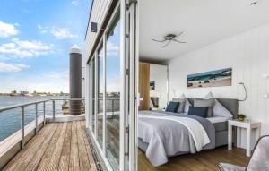 a bedroom with a bed on a balcony at Ankerplatz19B in Olpenitz +14 photos