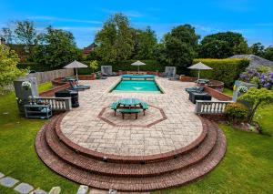 a pool with a table and chairs in a yard at Balmer Lawn in Brockenhurst