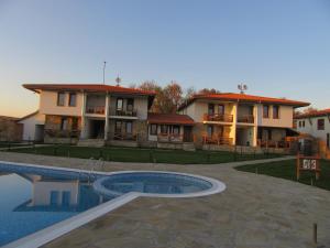 a villa with a swimming pool in front of a house at Комплекс Стара Плиска in Pliska