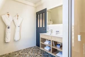 a bathroom with a sink and a mirror at Hôtel & Spa Madison Saint Jean de Luz in Saint-Jean-de-Luz
