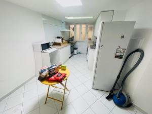 a kitchen with a small table and a refrigerator at Monaco Cote d Azur in Beausoleil