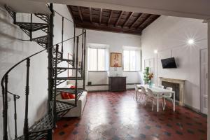 a living room with a spiral staircase and a table at De Bardi - Beautiful Home near Ponte Vecchio in Florence