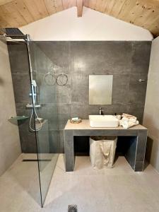 a bathroom with a sink and a shower at Chrysavgi Stone House in Meganisi