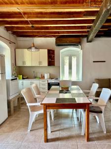 a kitchen and dining room with a table and chairs at Chrysavgi Stone House in Meganisi +24 photos