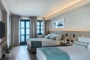 Postel nebo postele na pokoji v ubytování Aeifos Boutique Hotel