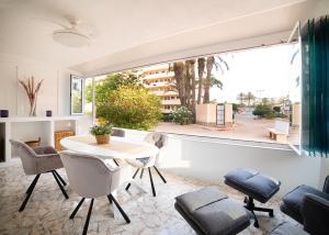 a room with a table and chairs and a large window at Maison Miramar Cabo Cervera in Torrevieja