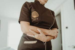 a man wearing a black shirt with his arms crossed at Garni Hotel Biser in Kru&scaron;evac