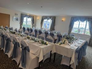 a room with tables and chairs in a room at Solway Lodge Hotel in Gretna Green