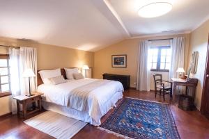 a bedroom with a bed and a table and chairs at Domaine de Saint Pons in Villars +54 photos