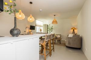 a kitchen and living room with a table and chairs at Boutiquehotel Omnia in Valkenburg