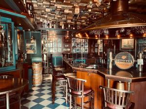 a bar with tables and chairs in a pub at Seehotel in Helgoland