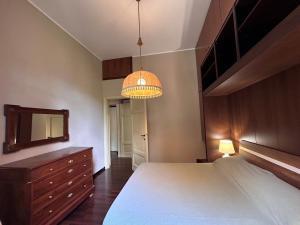 a bedroom with a bed and a dresser and a mirror at Casa Dolce Vita in Lenno