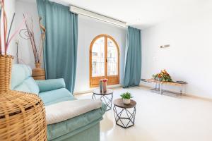 a living room with a blue couch and a window at Grand Villa Valencia- large groups-8 min to Center by Metro in Valencia