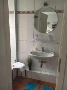 a bathroom with a sink and a mirror at Haus Schlüter in Helgoland