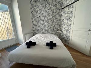 a bedroom with a bed with two crosses on it at Côté Plage - Plein centre de Binic in Binic-Etables-sur-Mer