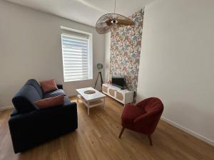 a living room with a couch and two chairs at Côté Plage - Plein centre de Binic in Binic-Etables-sur-Mer