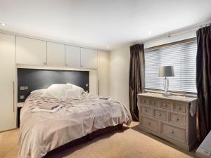 a bedroom with a large bed and a window at Cornwall Truro Falmouth cottage in Perranwell +8 photos