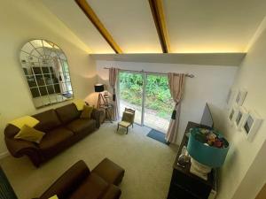 a living room with a couch and a window at Cornwall Truro Falmouth cottage in Perranwell