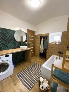 a bathroom with a washing machine and a washer at Na Gruntě in Škvořetice