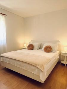 a bedroom with a bed with two pillows on it at Pina Hvar Apartment in Hvar