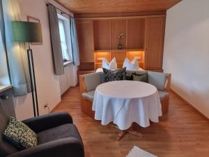 a room with a table and two chairs and a table at Menkenhof in Reit im Winkl