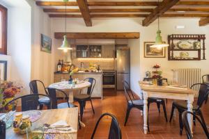 a kitchen and dining room with tables and chairs at Foresteria Castello di Verrazzano in Greve in Chianti