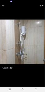 a shower in a bathroom with a water nozzle at 8 Adriatico Condotel Unit Facing Manila Bay in Manila
