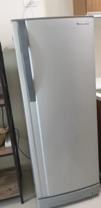 a white refrigerator freezer sitting on top of a counter at 8 Adriatico Condotel Unit Facing Manila Bay in Manila