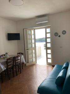 a living room with a couch and a table and a door at Vista Mare 1 in Marina di Camerota