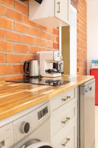 a kitchen with a brick wall and a counter top at Aparthotel Mediterráneo by NeoHotels-Centro 8 min by Metro in Valencia