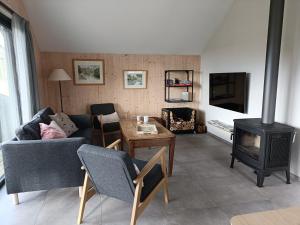 a living room with a couch and a wood stove at La clef des bois in Paliseul