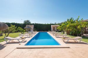 a pool with chaise lounge chairs and a bunch ofitures at NEW!!!!PLAYA, PISCINA y preciosa finca Can Amer en la costa este de Mallorca in S'Illot