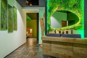 a bathroom with two sinks and a green wall at Love Room Evasion Duo in Marseille +22 photos