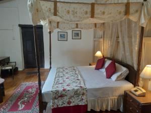 a bedroom with a bed with a canopy at West View Hotel in Rānīkhet